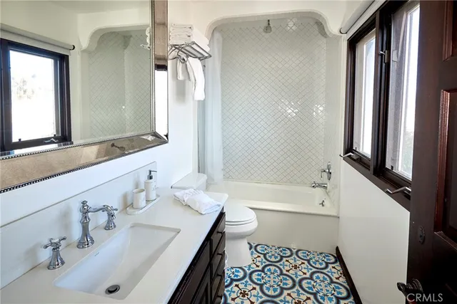 a bathroom with a sink mirror toilet and bathtub