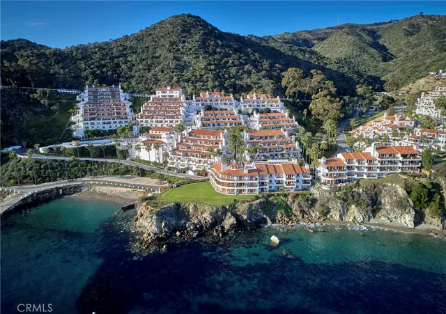 a view of a balcony with floor to ceiling windows and wooden fence