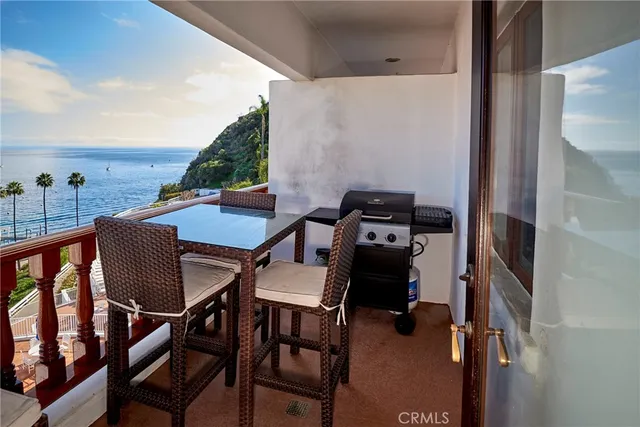 a balcony view with couple of chairs and wooden floor