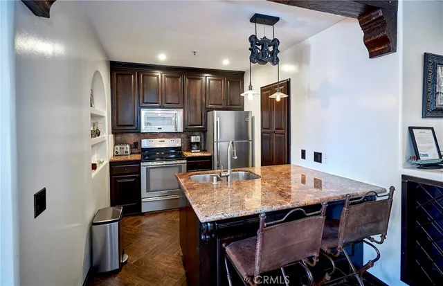a kitchen with kitchen island a dining table and chairs