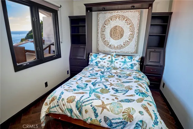 a bed with a bed and a painting on the wall