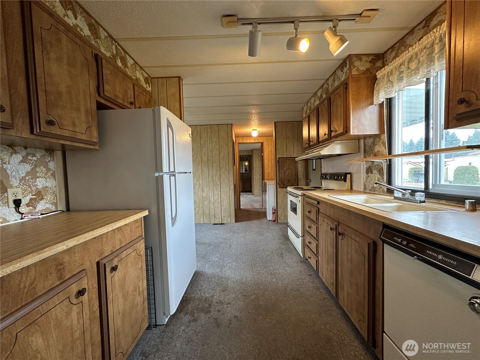 57 Clemons Road, Unit 49 Montesano, WA 98563 - Photo 13 of 23 a kitchen with stainless steel appliances granite countertop a sink and cabinets