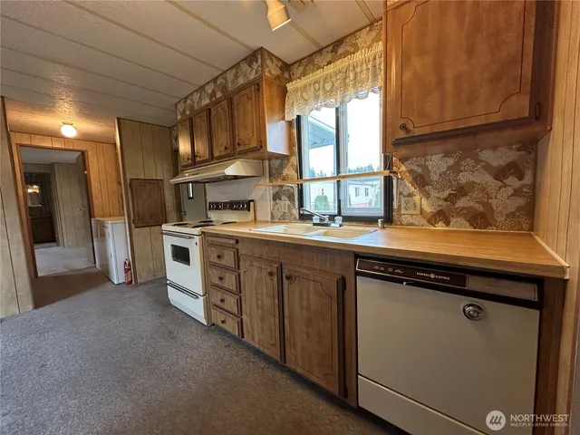 a bathroom with a granite countertop sink a window and a mirror