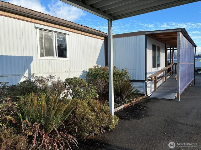 a view of a house with a small yard and plants
