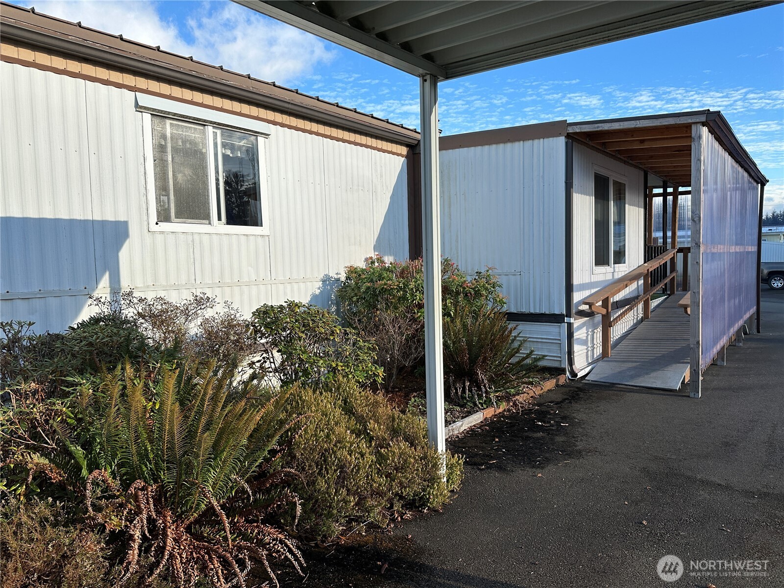 57 Clemons Road, Unit 49 Montesano, WA 98563 - Photo 4 of 23 a view of a house with a small yard and plants