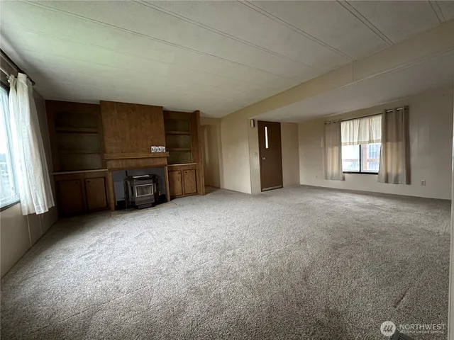 an empty room with furniture and window