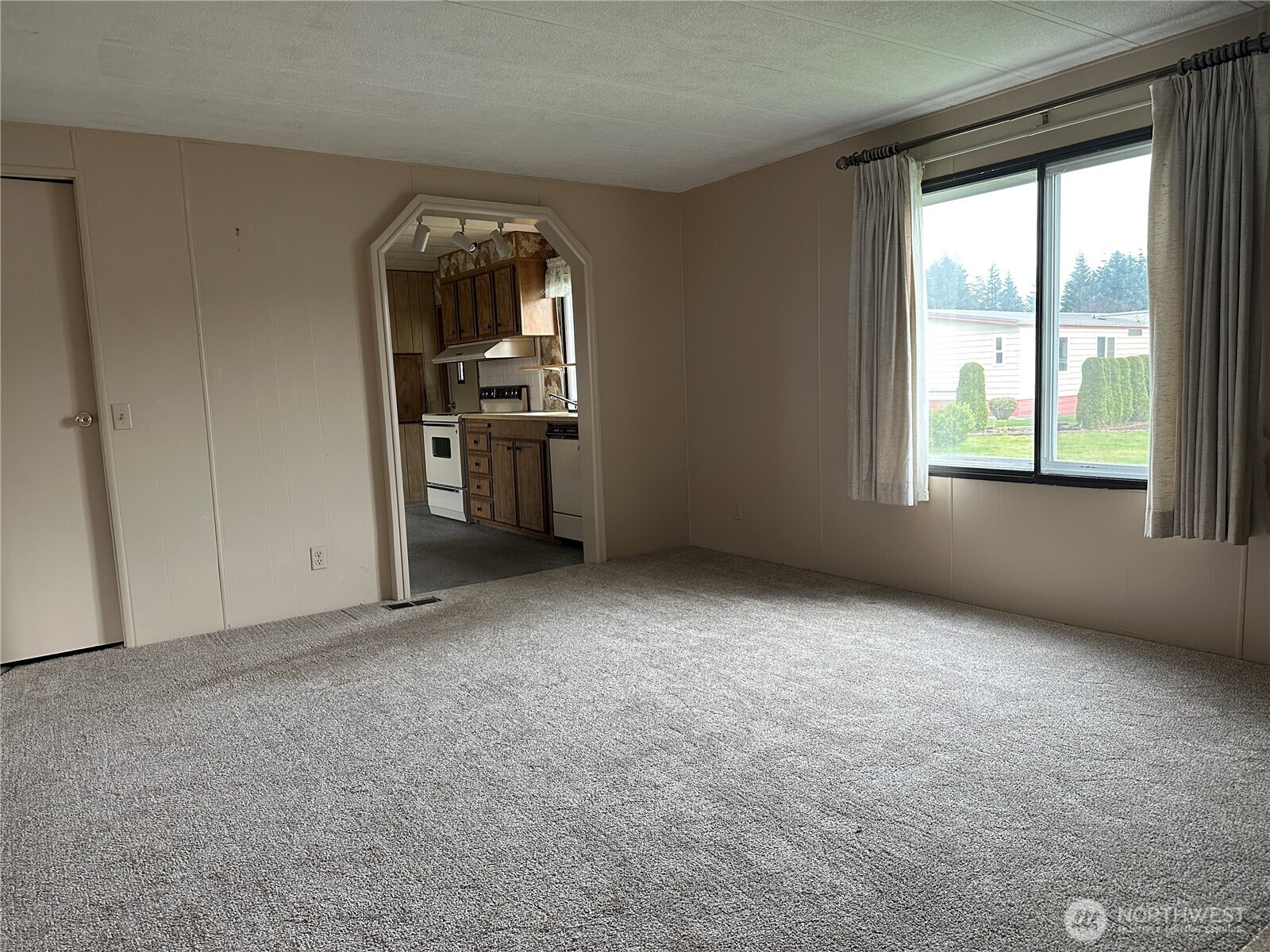 57 Clemons Road, Unit 49 Montesano, WA 98563 - Photo 7 of 23 an empty room with a fireplace and windows