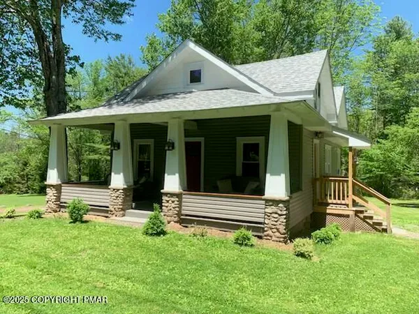 a view of small house with garden