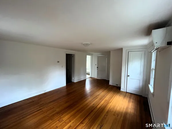 a view of an empty room and wooden floor