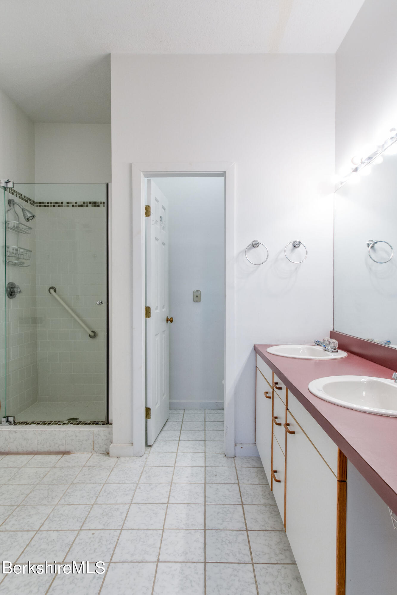 770 Summer Street, Unit 13B Lee, MA 01240 - Photo 15 of 39 a spacious bathroom with a granite countertop sink a mirror and a shower