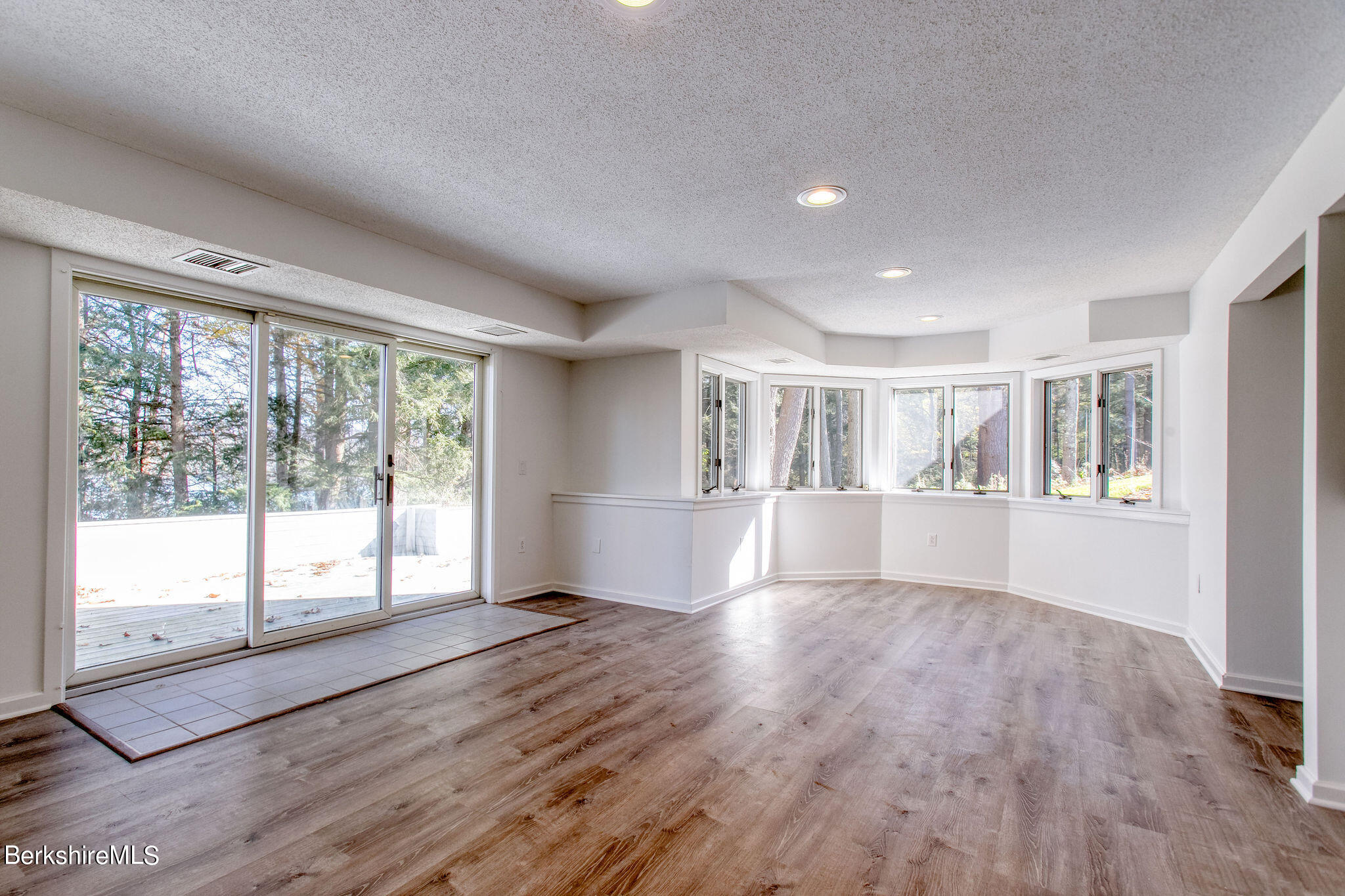 770 Summer Street, Unit 13B Lee, MA 01240 - Photo 23 of 39 a view of an empty room with wooden floor and a window