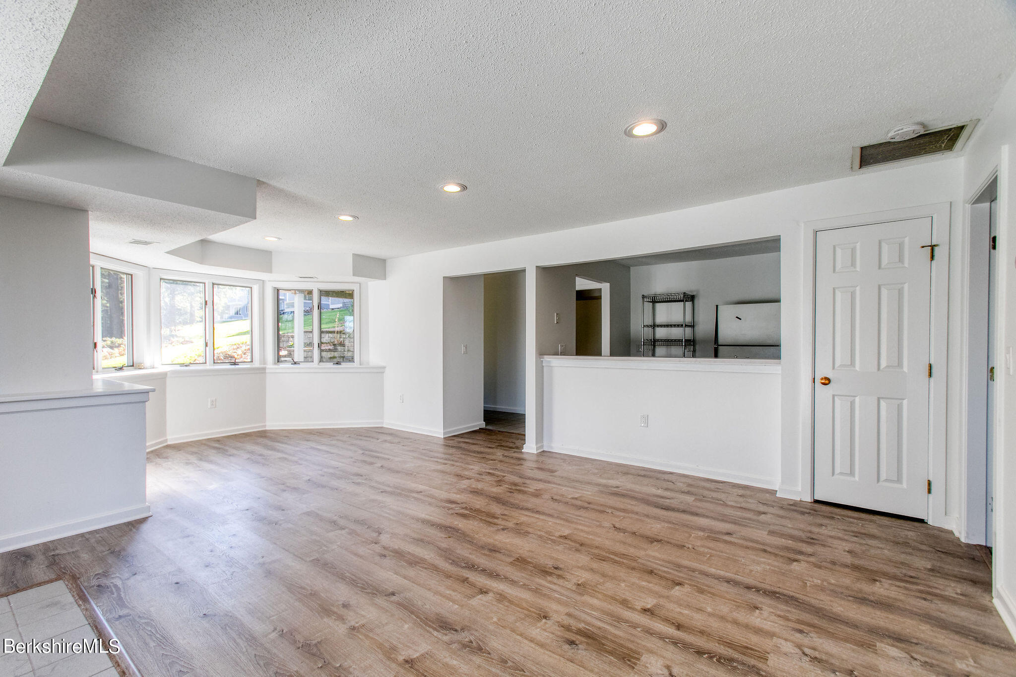 770 Summer Street, Unit 13B Lee, MA 01240 - Photo 26 of 39 an empty room with wooden floor and windows