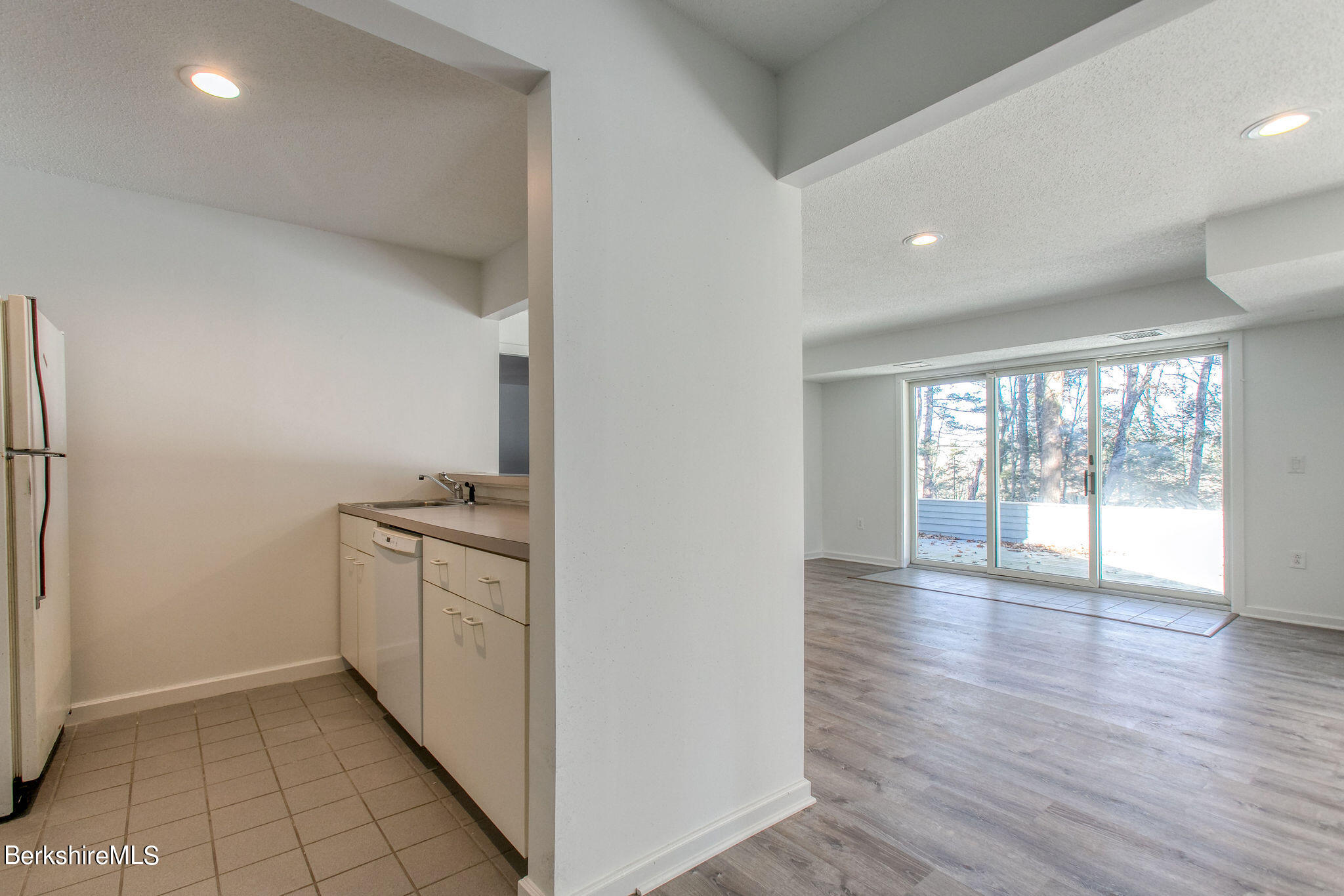 770 Summer Street, Unit 13B Lee, MA 01240 - Photo 27 of 39 an empty room with wooden floor and windows