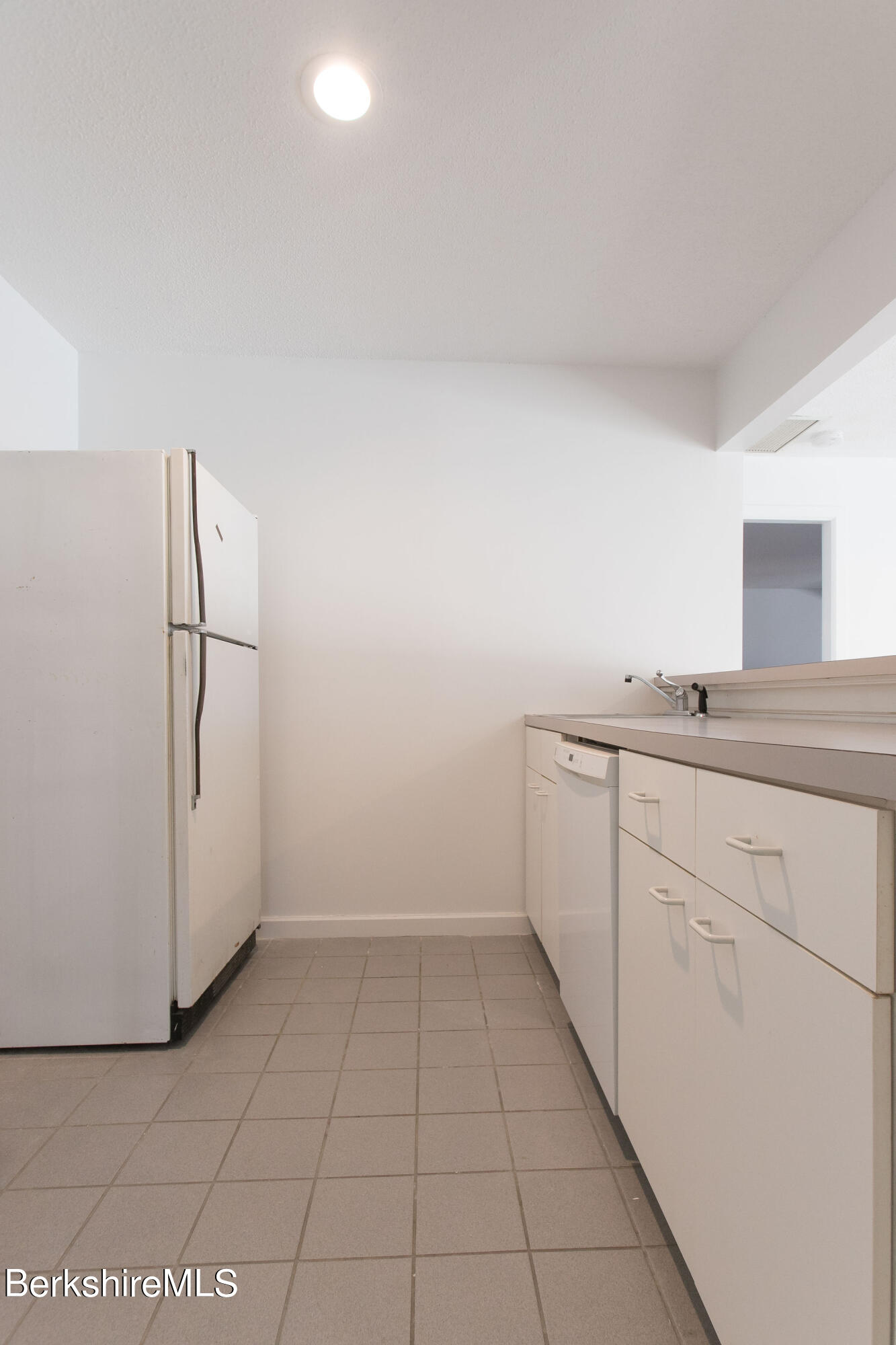 770 Summer Street, Unit 13B Lee, MA 01240 - Photo 28 of 39 a utility room with cabinets washer and dryer
