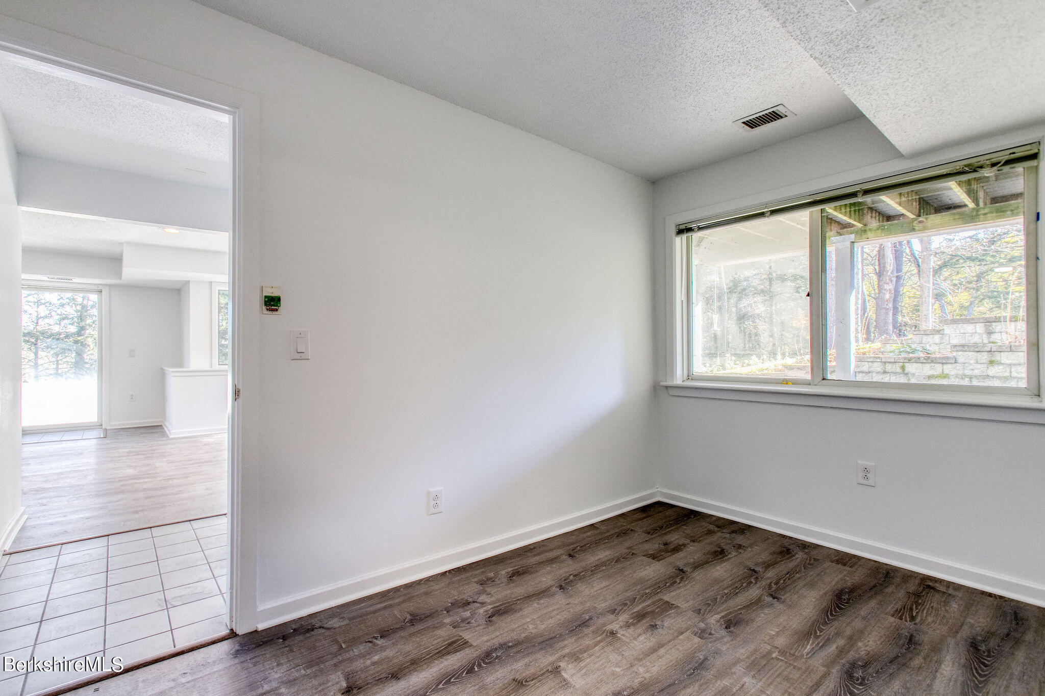 770 Summer Street, Unit 13B Lee, MA 01240 - Photo 31 of 39 an empty room with wooden floor and windows