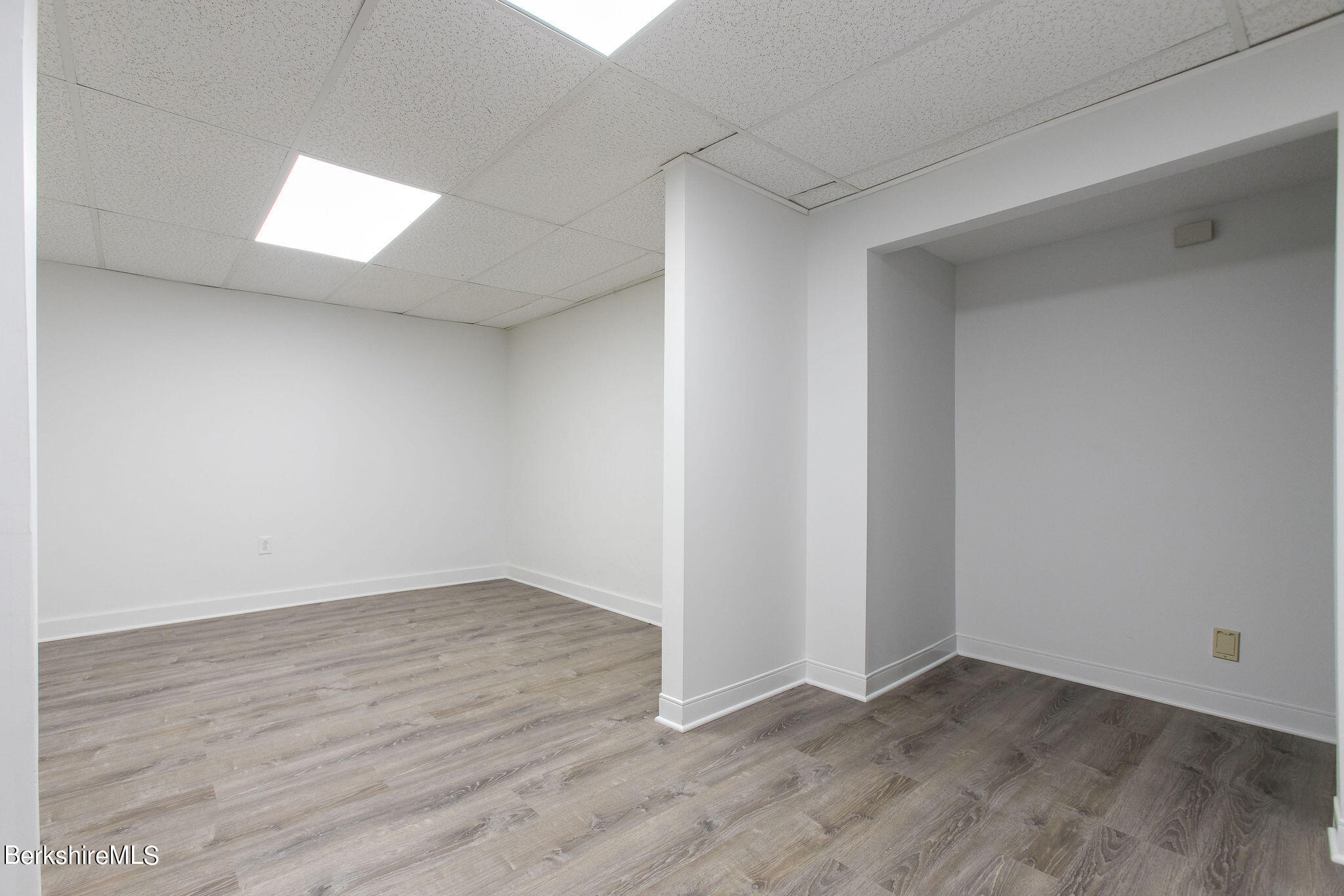 770 Summer Street, Unit 13B Lee, MA 01240 - Photo 32 of 39 an empty room with wooden floor and windows