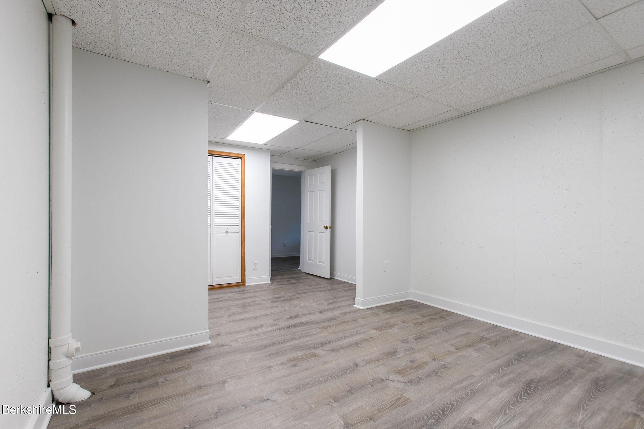 770 Summer Street, Unit 13B Lee, MA 01240 - Photo 33 of 39 an empty room with wooden floor and closet