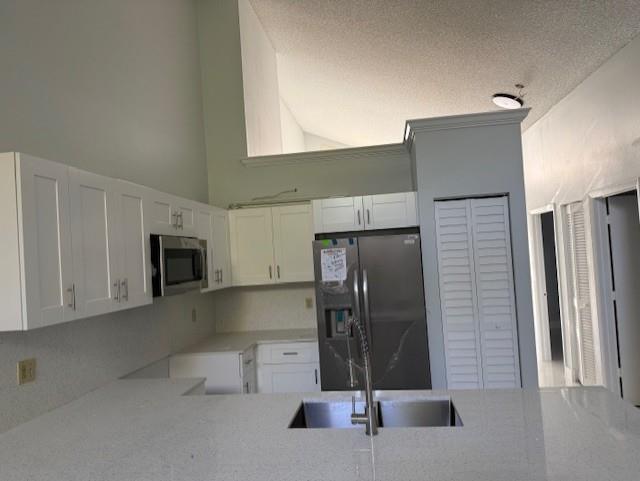 2355 Northwest 123rd Avenue Coral Springs, FL 33065 - Photo 3 of 10 a kitchen with stainless steel appliances a refrigerator and a sink