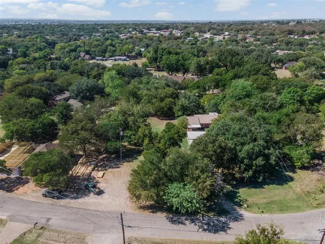 an aerial view of a forest with houses