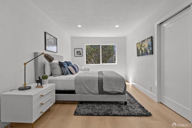 a spacious bedroom with a bed and a dresser