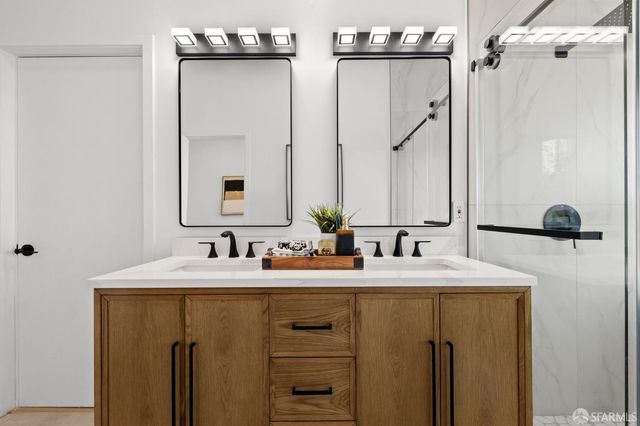 a bathroom with a double vanity sink and mirror