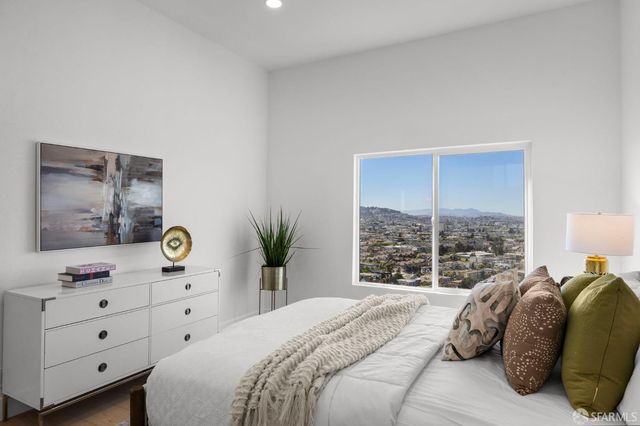 a bedroom with a large bed and a window