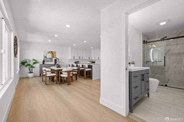 a view of a kitchen with furniture and a refrigerator