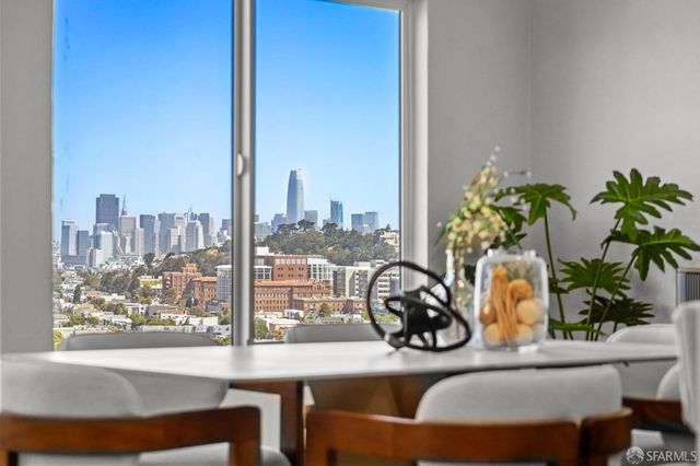 a view of a dining room with furniture window and flowerpot