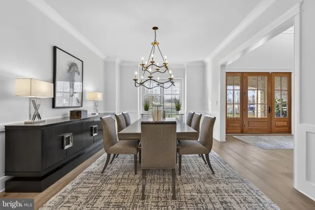 a living room with furniture a fireplace and a large window