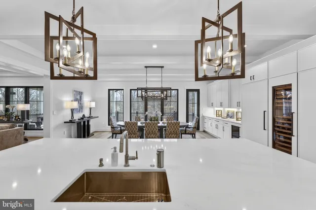 a living room with furniture and floor to ceiling windows