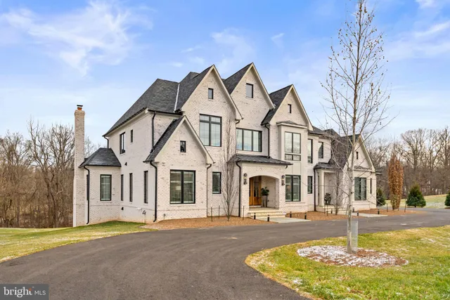a dining room with furniture potted plants and wooden floor