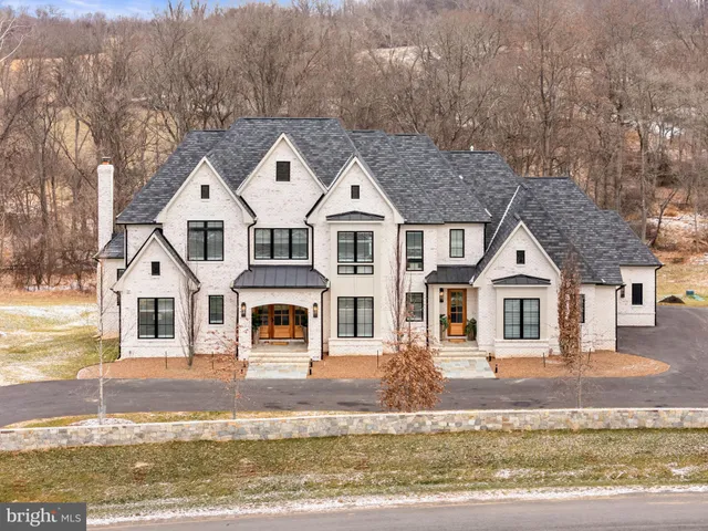 a large kitchen with cabinets wooden floor and stainless steel appliances