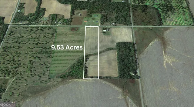 an aerial view of a houses with a yard