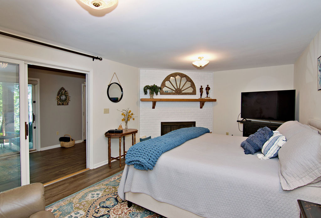 11001 Lake Ridge Lane Seneca, SC 29672 - Photo 37 of 50 A classic brick fireplace and sliding glass doors define this comfortable bedroom.