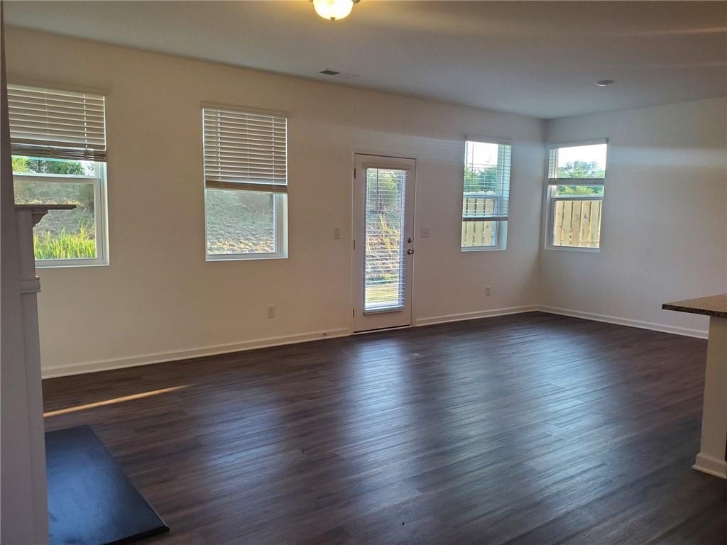 5745 Thornton Drive Cumming, GA 30028 - Photo 14 of 45 an empty room with wooden floor and windows