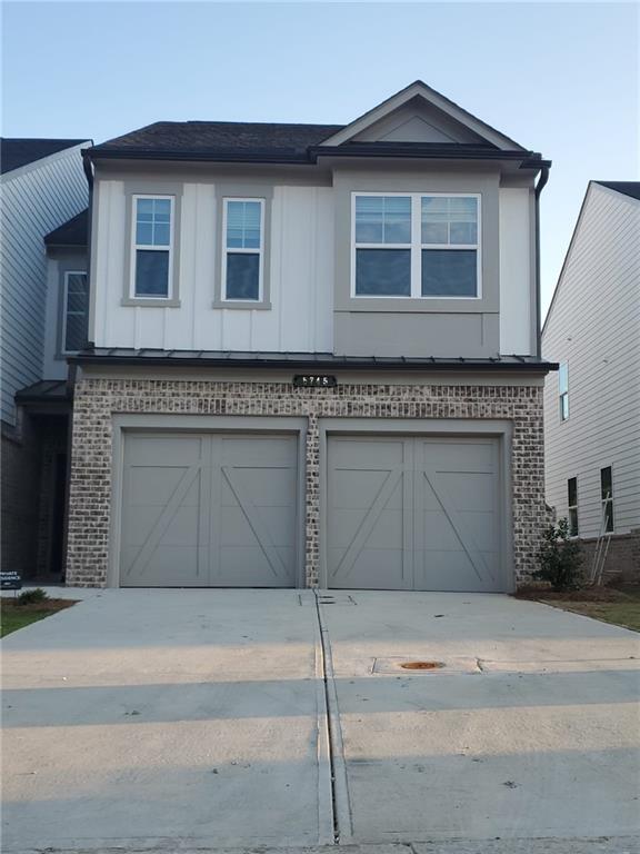 5745 Thornton Drive Cumming, GA 30028 - Photo 2 of 45 a front view of a house with garage