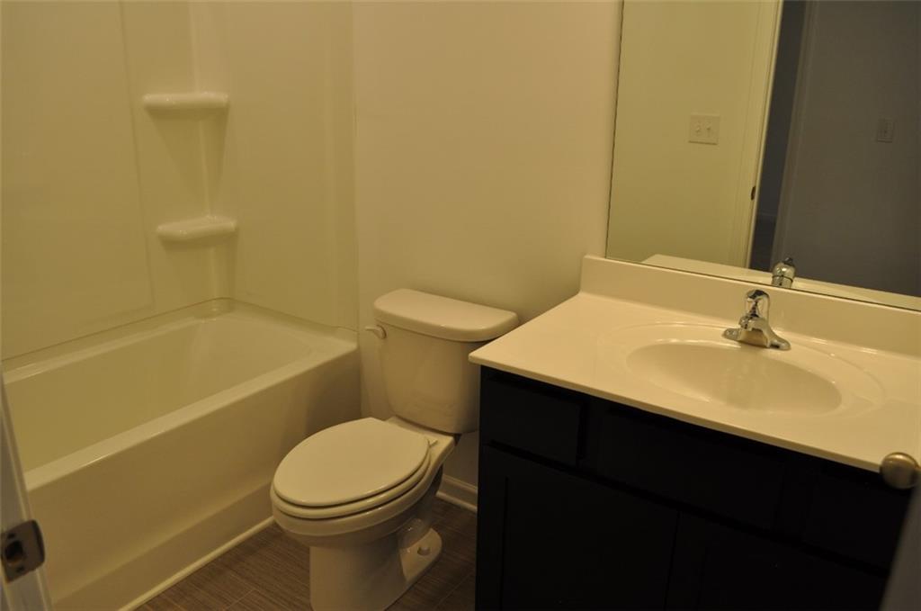 5745 Thornton Drive Cumming, GA 30028 - Photo 21 of 45 a bathroom with a sink a toilet and shower