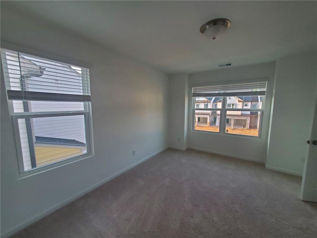 5745 Thornton Drive Cumming, GA 30028 - Photo 22 of 45 a view of an empty room with a window