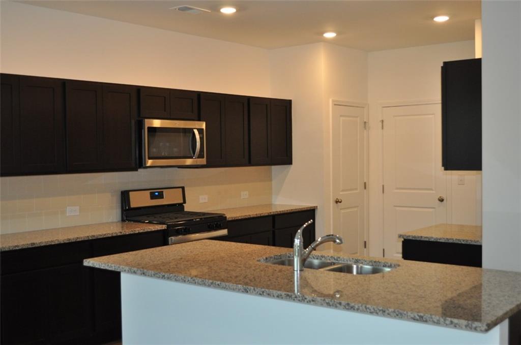 5745 Thornton Drive Cumming, GA 30028 - Photo 3 of 45 a kitchen with a sink and a microwave