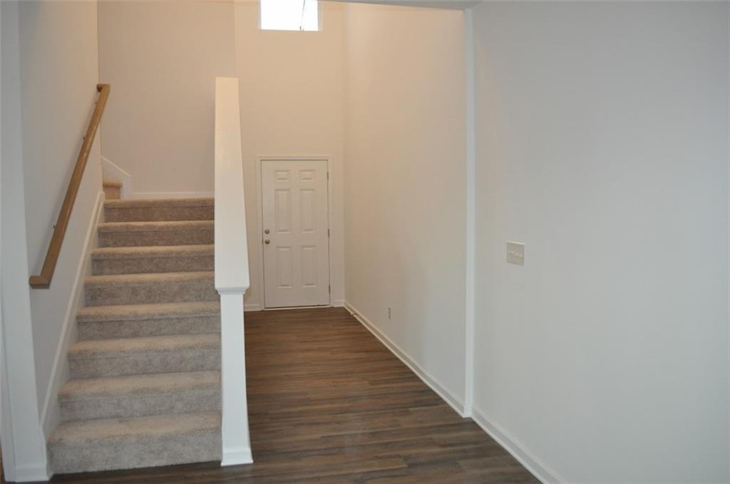 5745 Thornton Drive Cumming, GA 30028 - Photo 33 of 45 a view of a hallway with wooden floor and entryway