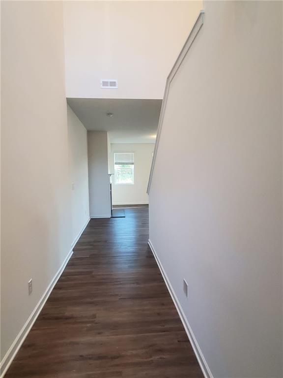 5745 Thornton Drive Cumming, GA 30028 - Photo 34 of 45 a view of a hallway with wooden floor