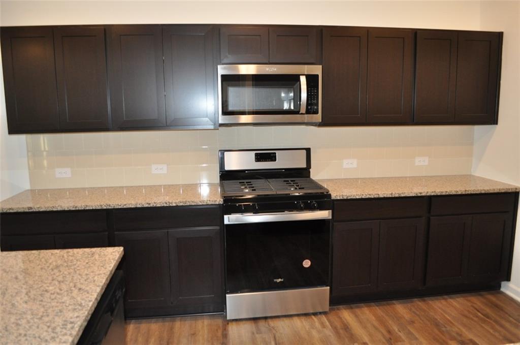 5745 Thornton Drive Cumming, GA 30028 - Photo 6 of 45 a kitchen with a sink and a microwave