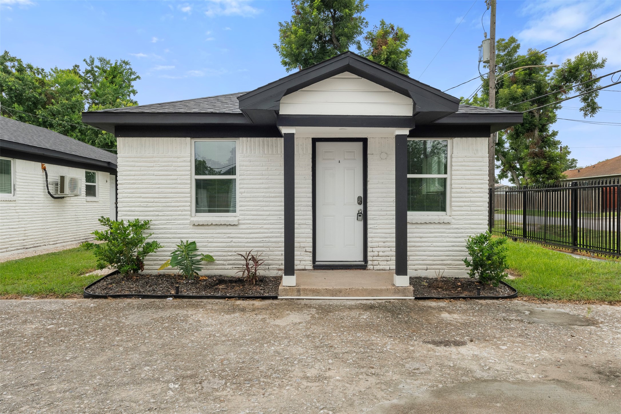 4116 Linn Street, Unit A Houston, TX 77026 - Photo 1 of 8 a front view of a house with garden