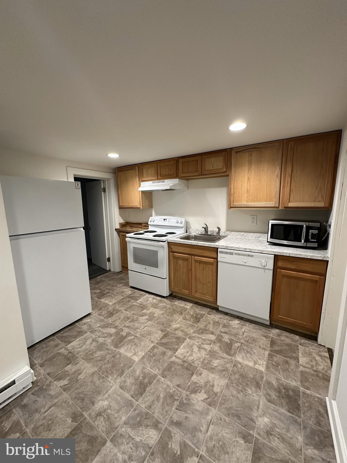 45 Warrenton Road, Unit 2 Fredericksburg, VA 22405 - Photo 2 of 8 a kitchen with a sink a refrigerator and cabinets