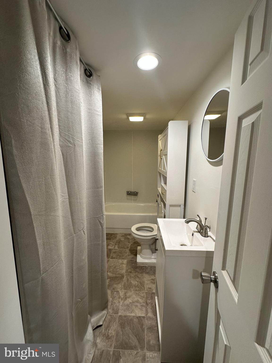 45 Warrenton Road, Unit 2 Fredericksburg, VA 22405 - Photo 4 of 8 a bathroom with a sink a mirror and a shower