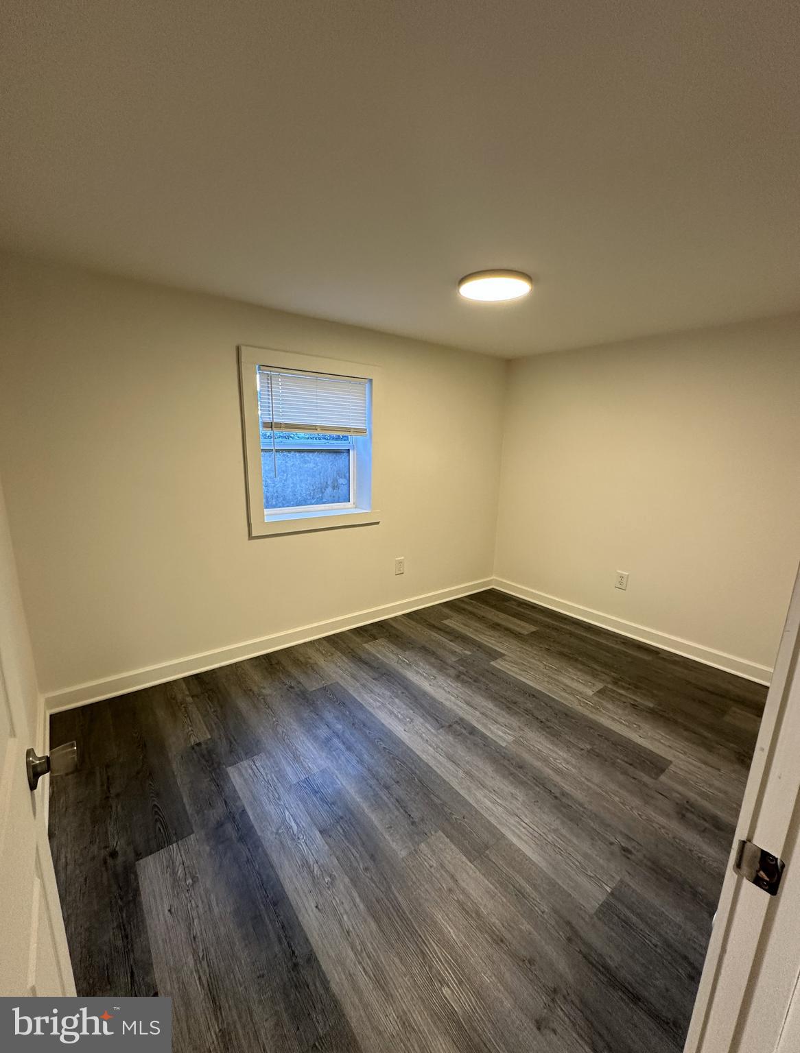 45 Warrenton Road, Unit 2 Fredericksburg, VA 22405 - Photo 7 of 8 an empty room with wooden floor and windows