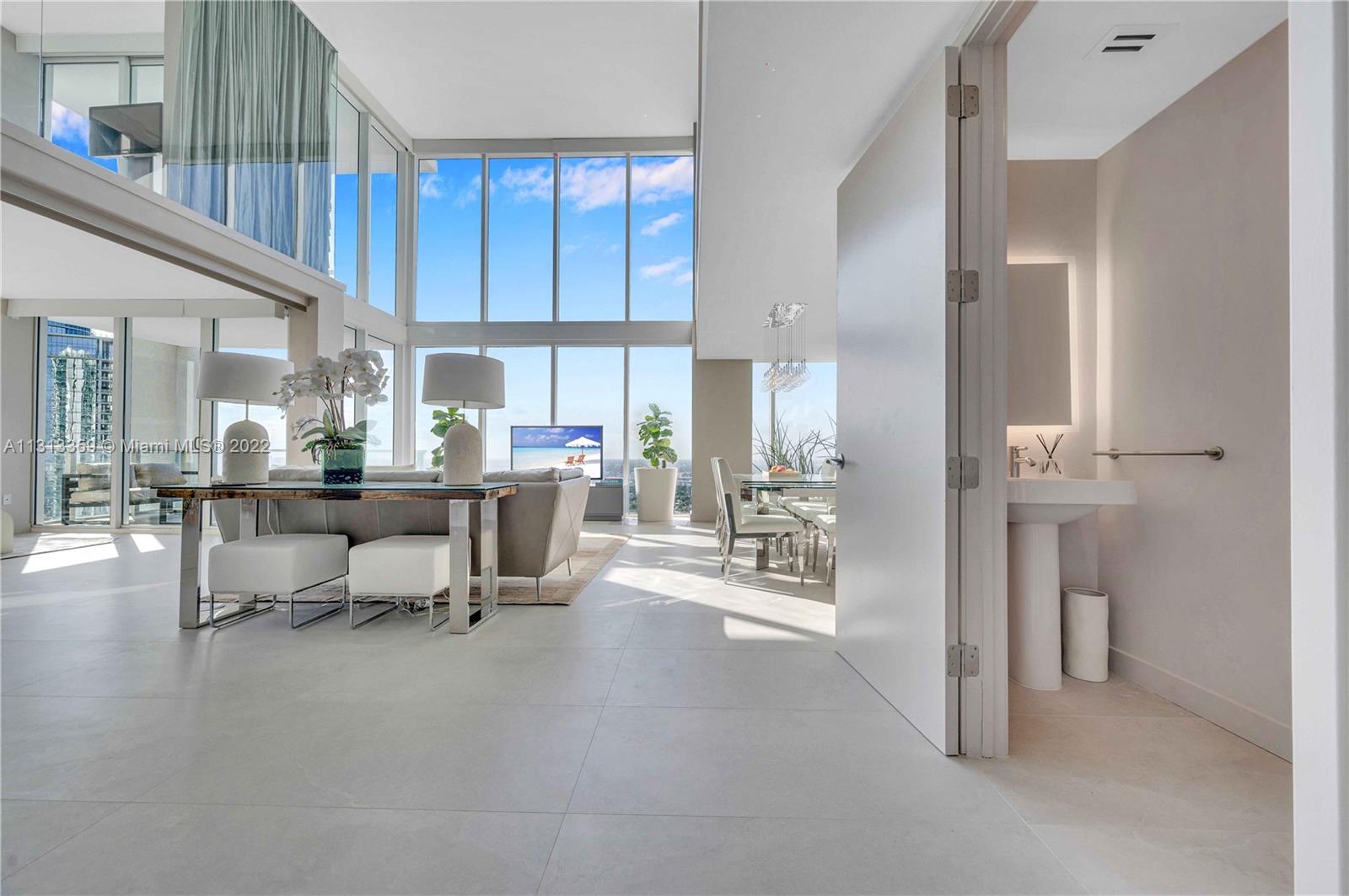 1040 Biscayne Boulevard, Unit PH4407 Miami, FL 33132 - Photo 14 of 74 a living room with furniture a large window and chairs