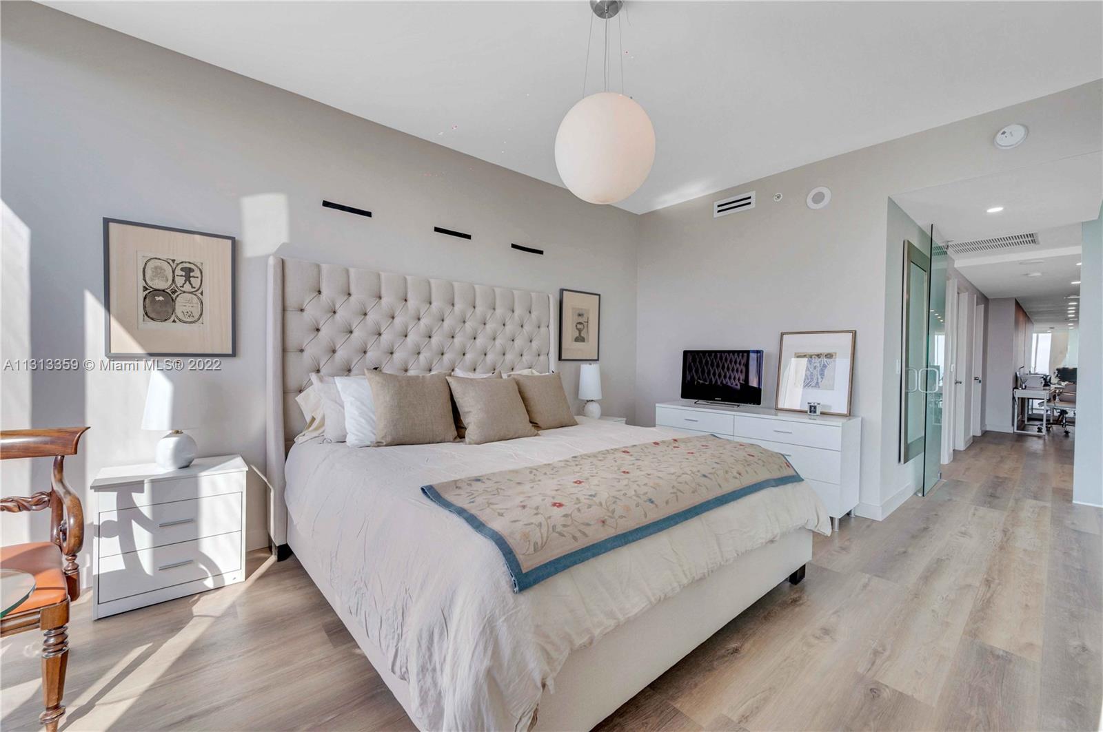 1040 Biscayne Boulevard, Unit PH4407 Miami, FL 33132 - Photo 33 of 74 a spacious bedroom with a large bed and a flat screen tv