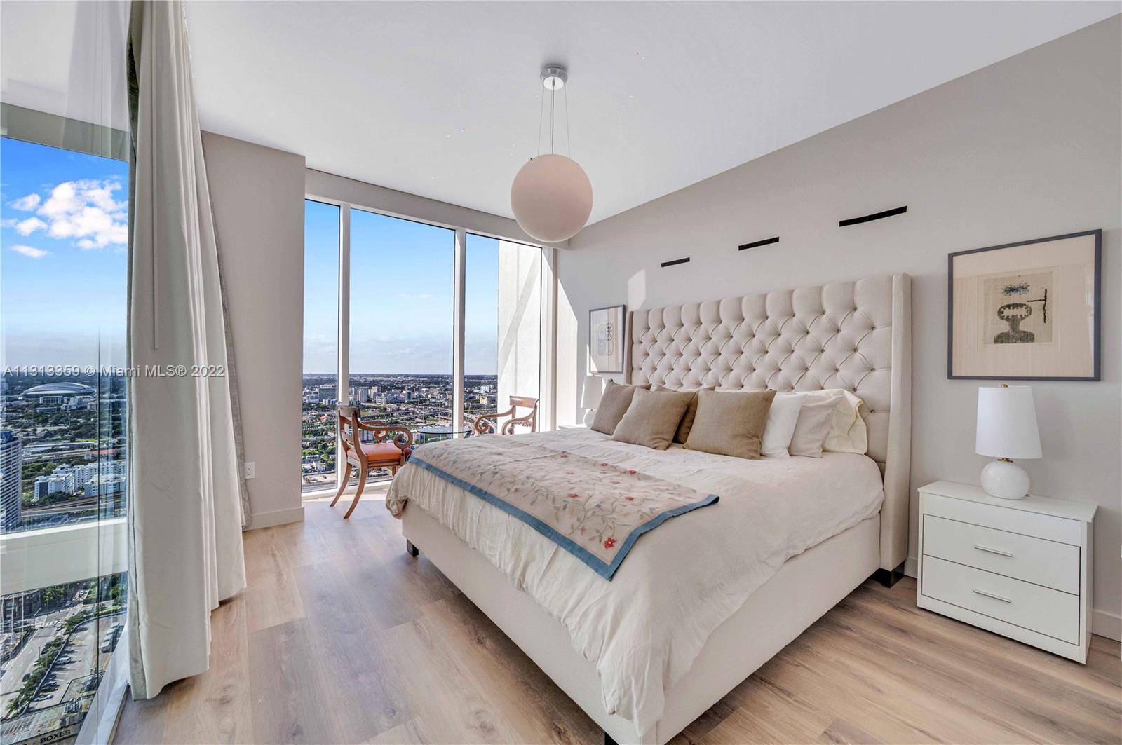 1040 Biscayne Boulevard, Unit PH4407 Miami, FL 33132 - Photo 34 of 74 a bedroom with a bed mirror and window