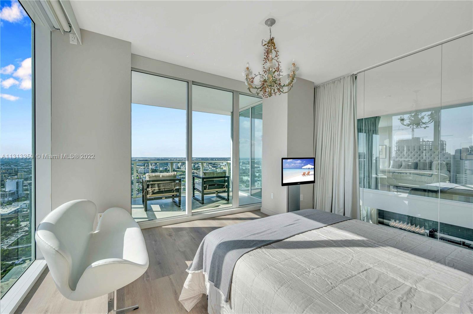 1040 Biscayne Boulevard, Unit PH4407 Miami, FL 33132 - Photo 40 of 74 a bedroom with a large bed and a chandelier